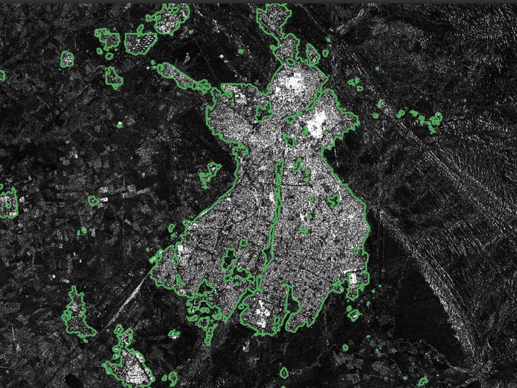 Radar image of Kirkouk with predicted building-area boundaries outlined in green.