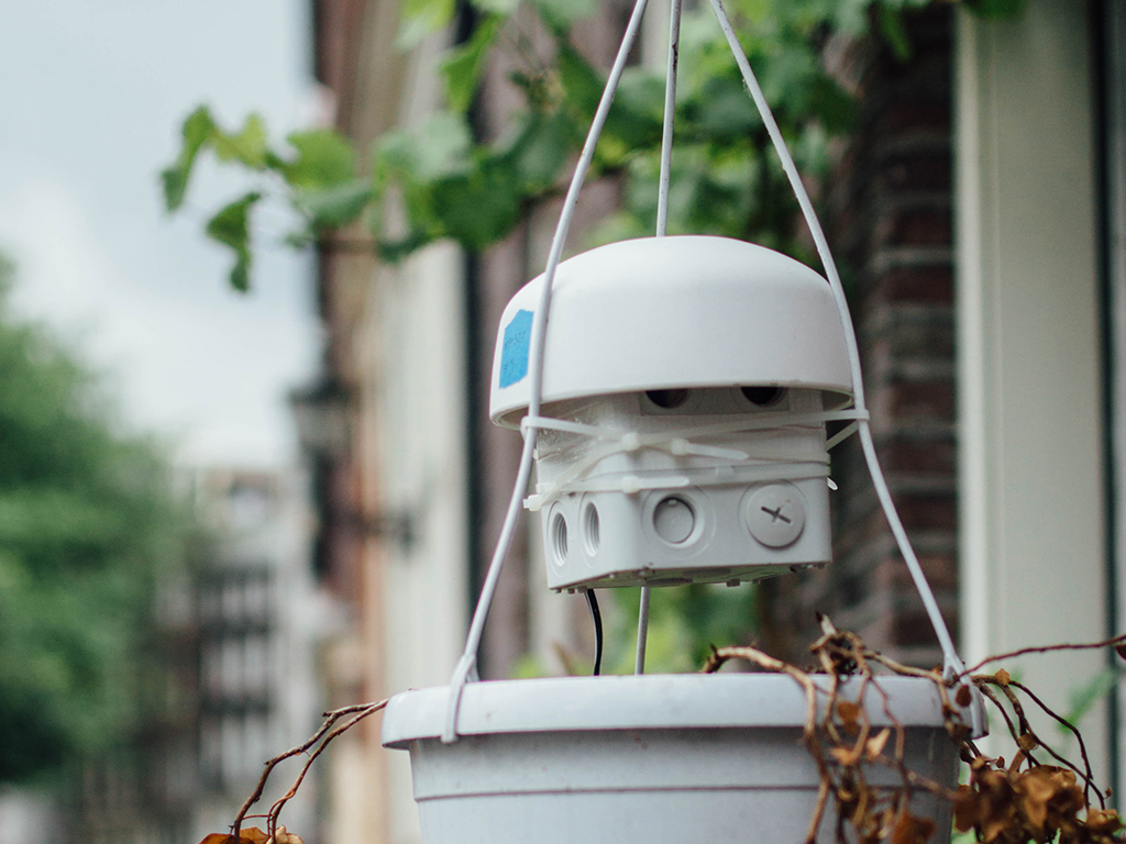 Air-quality sensor suspended outside an Amsterdam home during the Urban AirQ pilot.